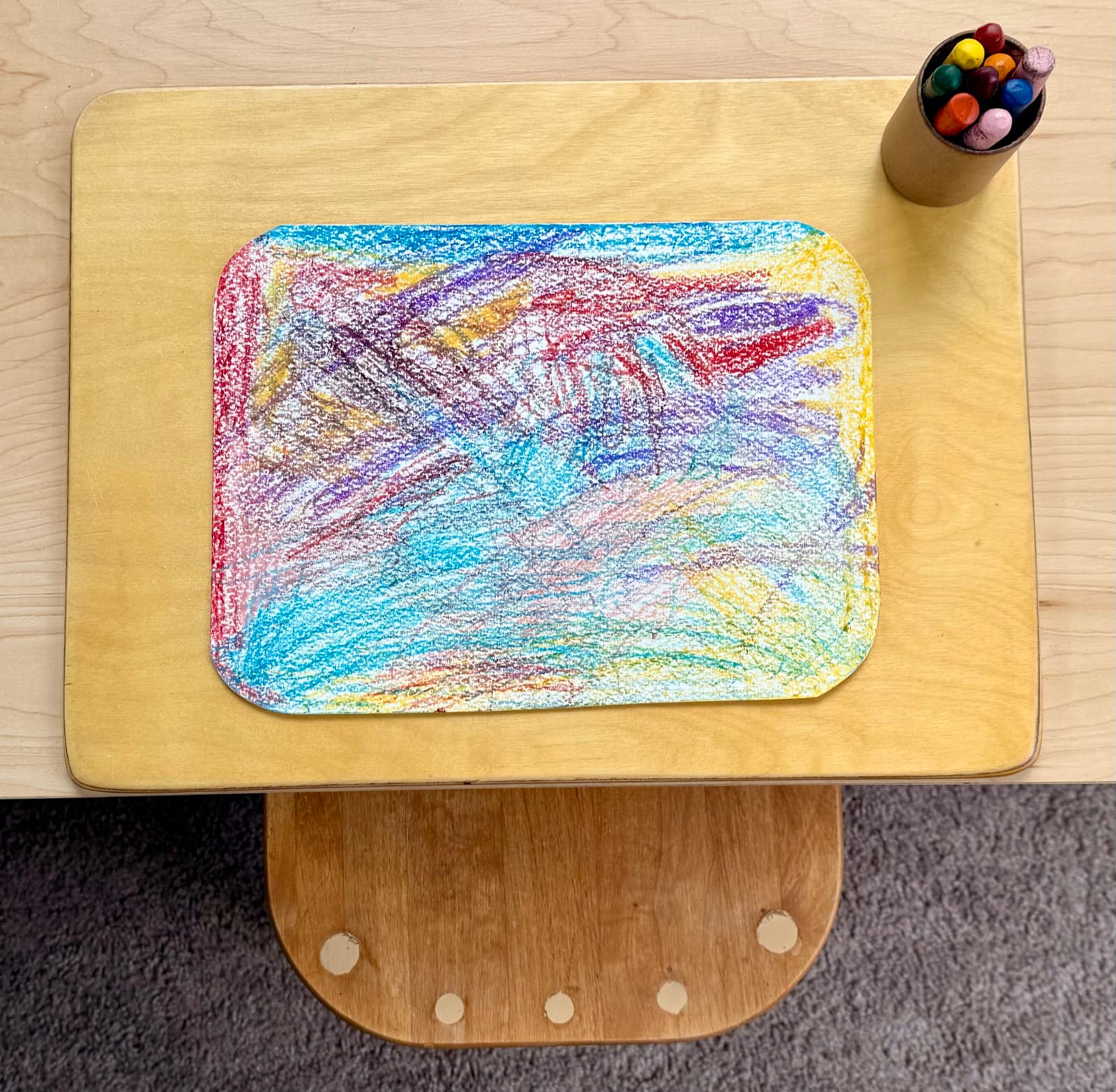 A layered, abstract crayon drawing made in class