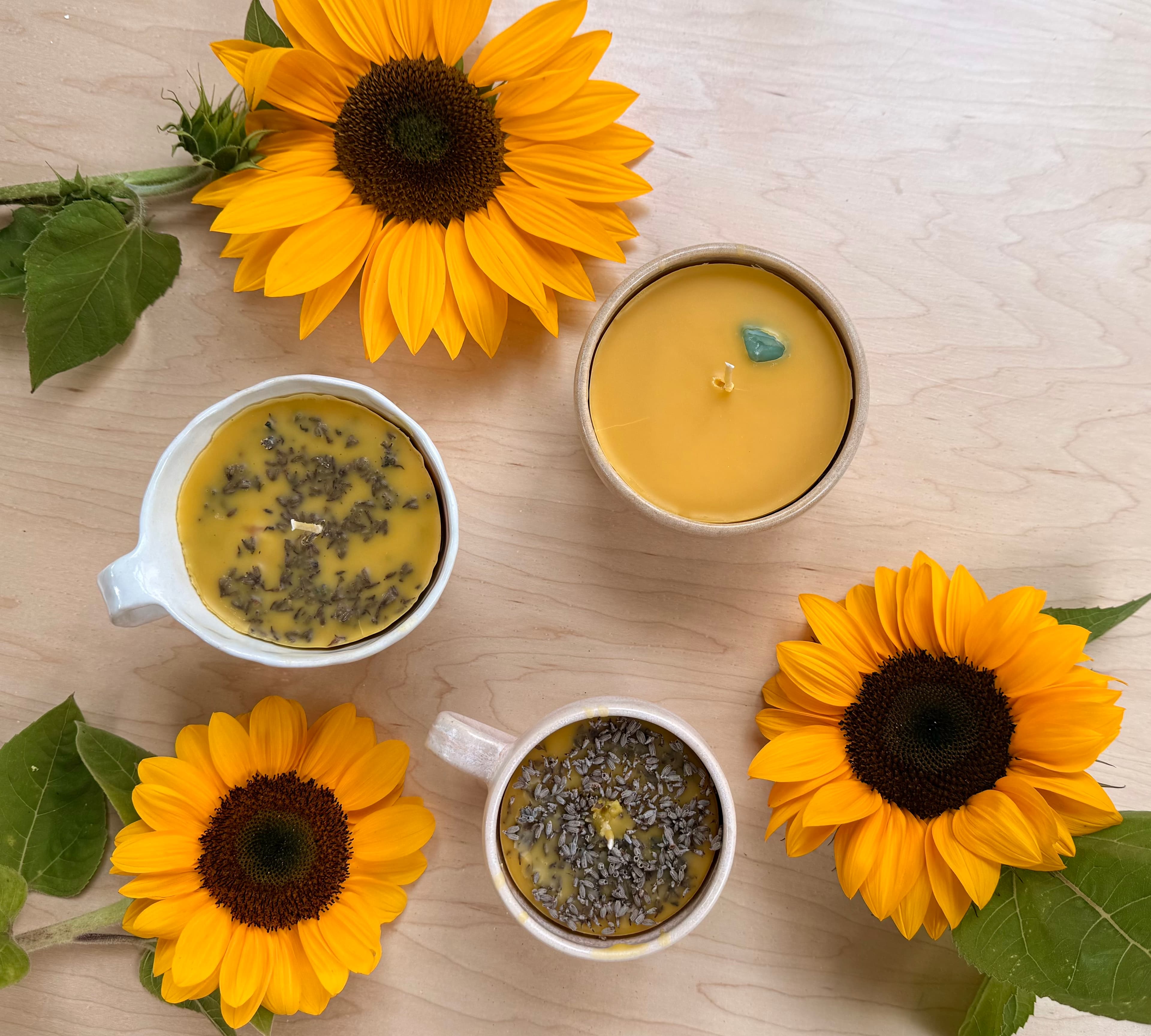 Handmade beeswax candles with pressed lavender, surrounded by sunflowers