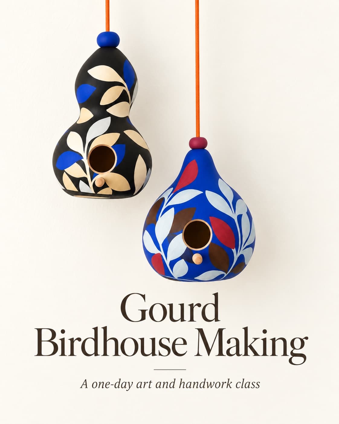 Two dried gourds painted with bold leaf patterns and hung as birdhouses
